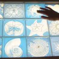 Interactive pattern matching game devised by Richard Henry for British Library installation, in which children move incised panels over illuminated graphics.